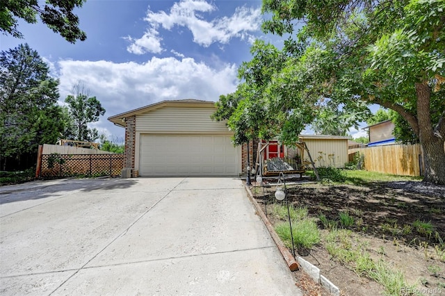 4738 Dover Dr, Colorado Springs, CO 80916 - view of front of house with concrete driveway, an attached garage, and brick siding