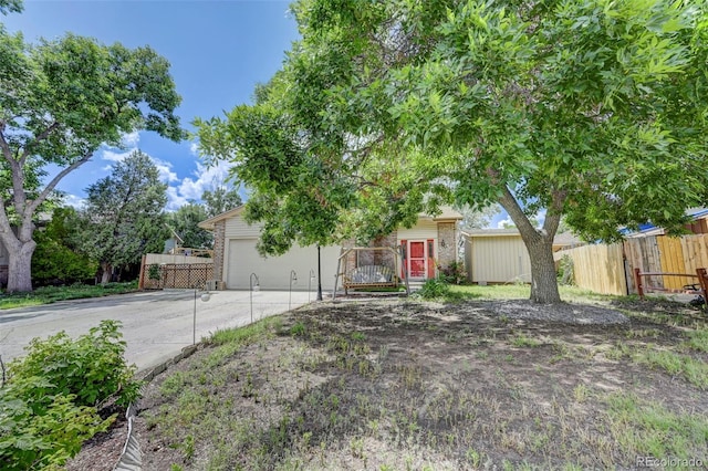 4738 Dover Dr, Colorado Springs, CO 80916 - obstructed view of property featuring driveway and a garage