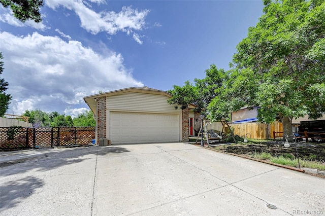 4738 Dover Dr, Colorado Springs, CO 80916 - view of front of house with concrete driveway, brick siding, and a garage