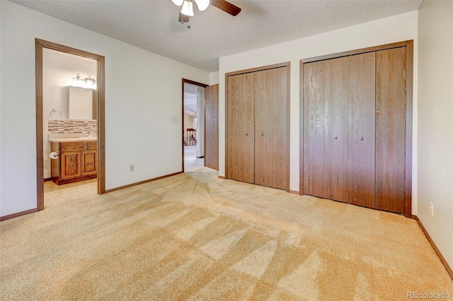 4738 Dover Dr, Colorado Springs, CO 80916 - unfurnished bedroom with two closets, carpet floors, ensuite bath, a textured ceiling, and ceiling fan