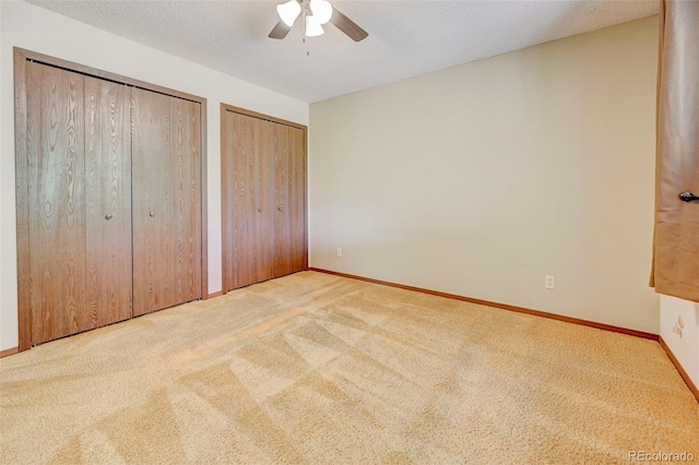 4738 Dover Dr, Colorado Springs, CO 80916 - unfurnished bedroom featuring multiple closets, carpet flooring, and a ceiling fan