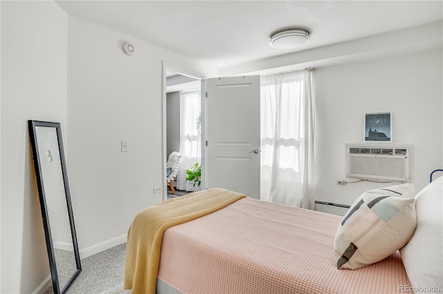1150 Vine St Unit 201, Denver, CO 80206 - carpeted bedroom featuring a wall mounted AC, baseboards, and a baseboard heating unit