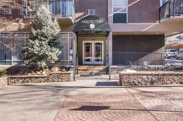 1150 Vine St Unit 201, Denver, CO 80206 - view of exterior entry featuring french doors and brick siding