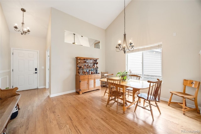 2753 E 139th Dr, Thornton, CO 80602 - dining room featuring a chandelier, high vaulted ceiling, and light wood-style flooring