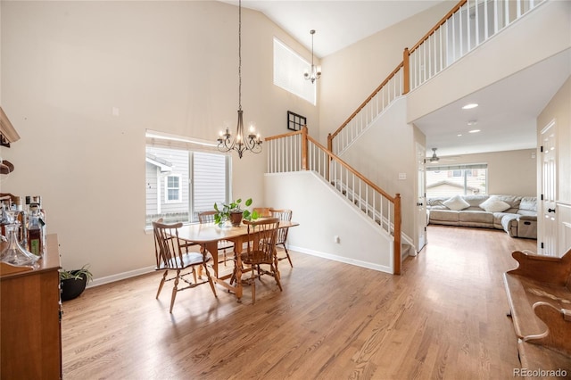 2753 E 139th Dr, Thornton, CO 80602 - dining room featuring high vaulted ceiling, stairway, a chandelier, wood finished floors, and ceiling fan