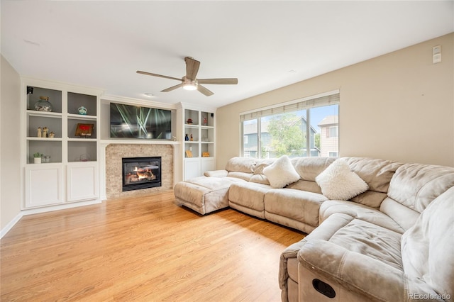 2753 E 139th Dr, Thornton, CO 80602 - living room featuring light wood-style floors, ceiling fan, and a glass covered fireplace