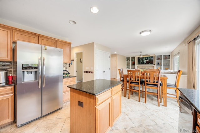 2753 E 139th Dr, Thornton, CO 80602 - kitchen with appliances with stainless steel finishes, a kitchen island, backsplash, dark stone countertops, and ceiling fan