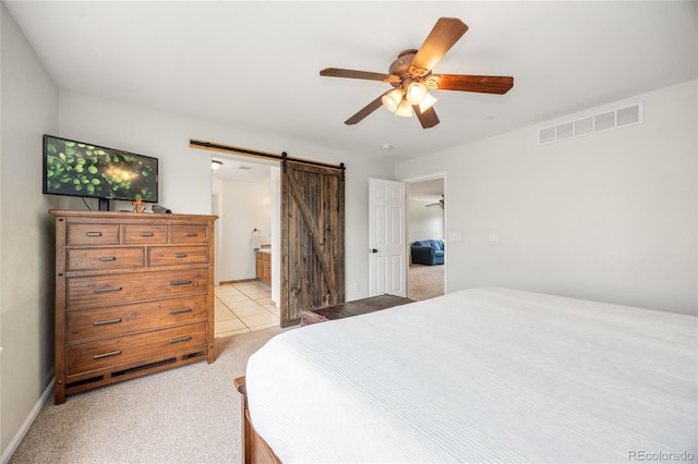 2753 E 139th Dr, Thornton, CO 80602 - bedroom featuring a barn door, light carpet, ceiling fan, and ensuite bathroom
