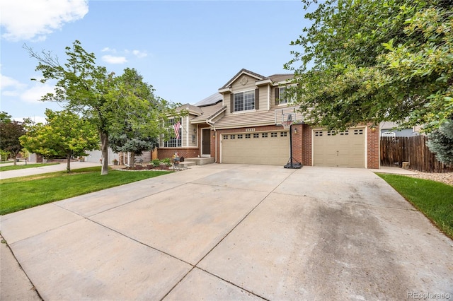 2753 E 139th Dr, Thornton, CO 80602 - view of front of home featuring brick siding, a garage, driveway, and solar panels