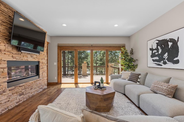 living room with wood finished floors, a fireplace, and recessed lighting