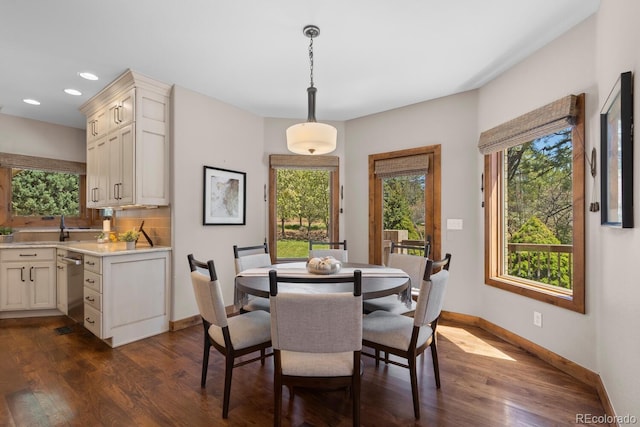 dining space featuring recessed lighting, baseboards, plenty of natural light, and dark wood finished floors