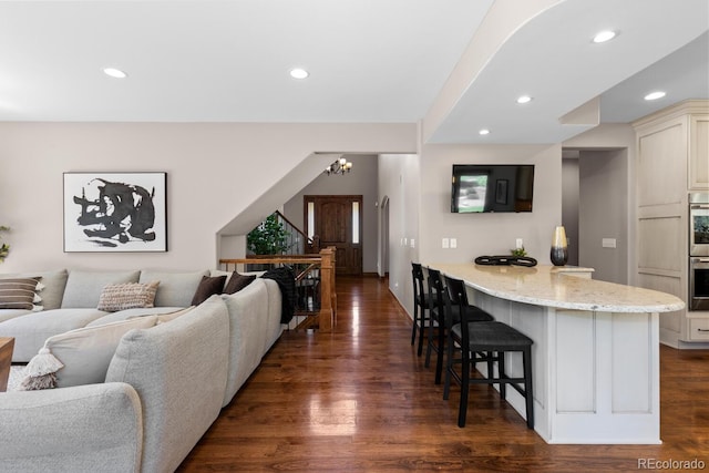 living area with a chandelier, dark wood-style flooring, and recessed lighting
