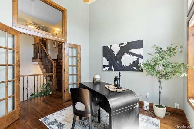 office space with a ceiling fan and wood finished floors