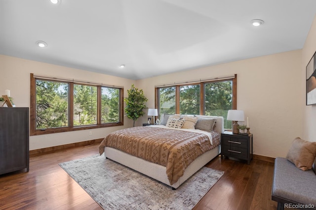 bedroom featuring baseboards and dark wood-style flooring