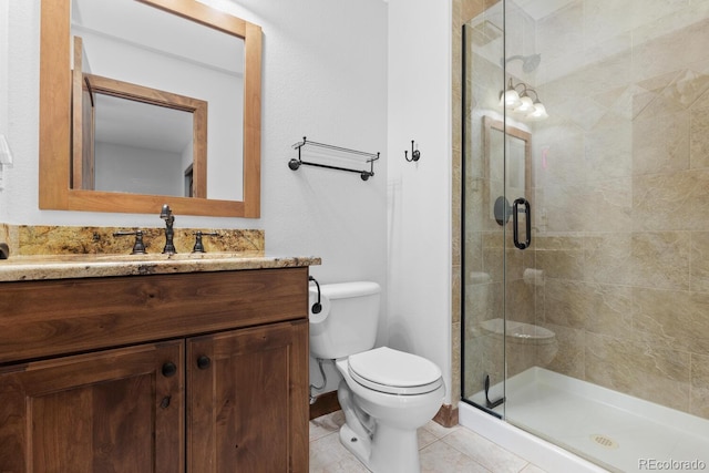 bathroom featuring toilet, tile patterned flooring, vanity, and a shower stall