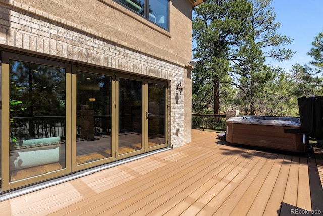 wooden terrace featuring a hot tub and french doors