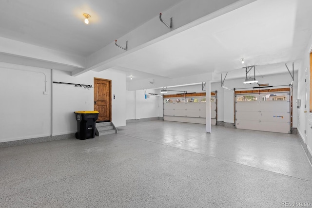 garage featuring baseboards and a garage door opener