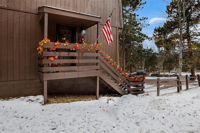 view of snow covered property entrance