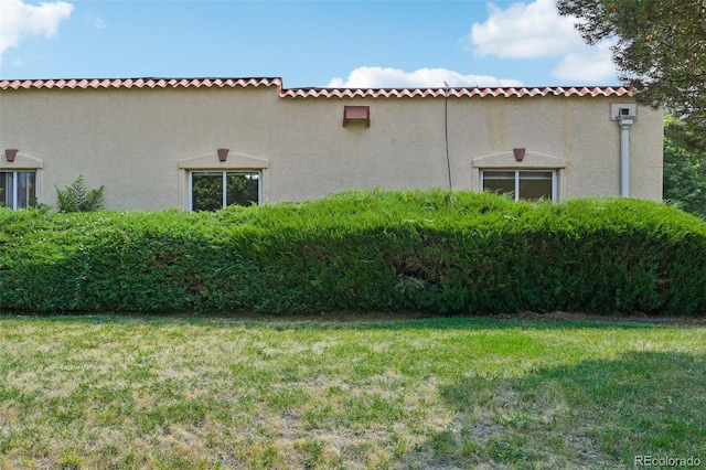 view of property exterior featuring a yard