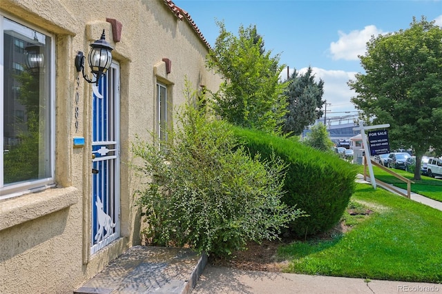 view of property exterior featuring a lawn