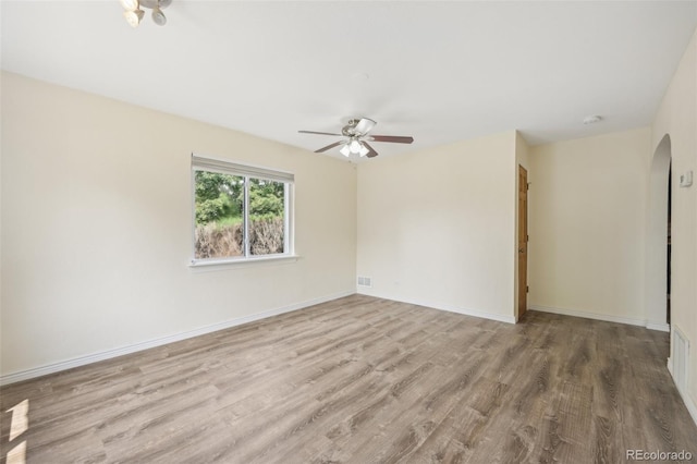 spare room featuring light hardwood / wood-style floors and ceiling fan