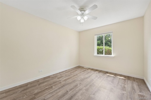 unfurnished room featuring ceiling fan and light wood-type flooring