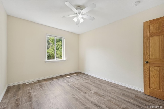 spare room with ceiling fan and light hardwood / wood-style flooring