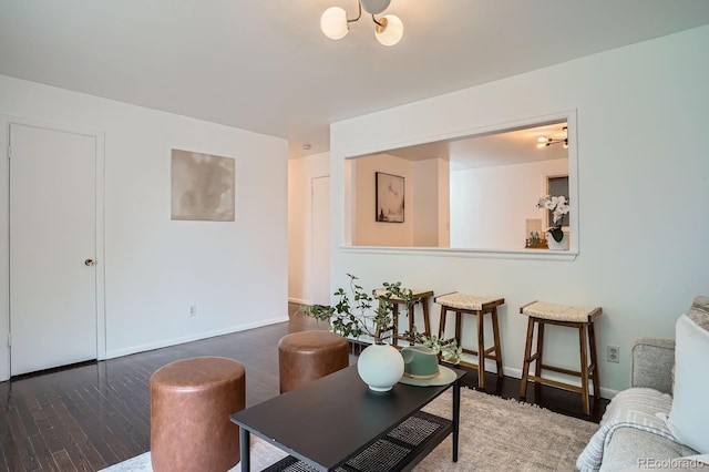 7618 Umatilla St, Denver, CO 80221 - living room featuring wood finished floors, a chandelier, and baseboards