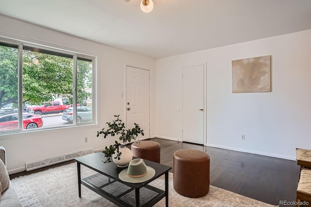 7618 Umatilla St, Denver, CO 80221 - living room with wood finished floors, baseboards, and radiator
