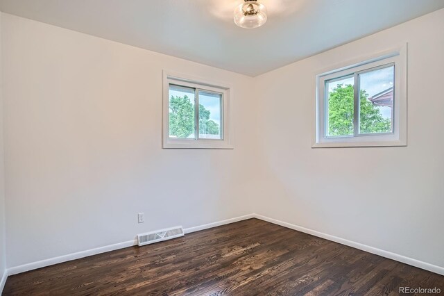 7618 Umatilla St, Denver, CO 80221 - empty room featuring healthy amount of natural light, baseboards, and dark wood-style flooring