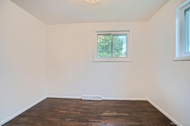 7618 Umatilla St, Denver, CO 80221 - empty room with plenty of natural light, wood finished floors, and baseboards