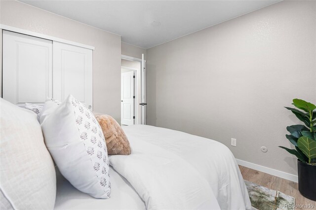 2260 S Lewiston St, Aurora, CO 80013 - bedroom with wood finished floors and a closet