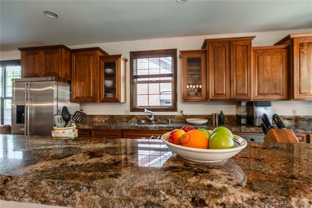 690 S Emerson St, Denver, CO 80209 - kitchen featuring stainless steel fridge with ice dispenser, brown cabinetry, glass insert cabinets, and recessed lighting