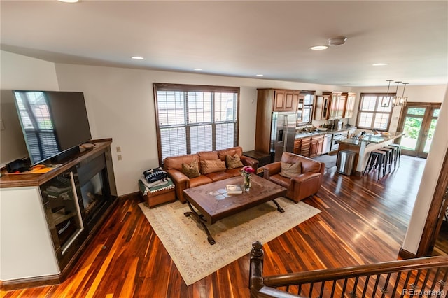 690 S Emerson St, Denver, CO 80209 - living room with dark wood finished floors, recessed lighting, and a glass covered fireplace