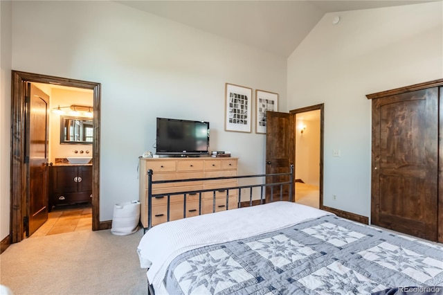 690 S Emerson St, Denver, CO 80209 - bedroom featuring high vaulted ceiling, light colored carpet, and ensuite bath