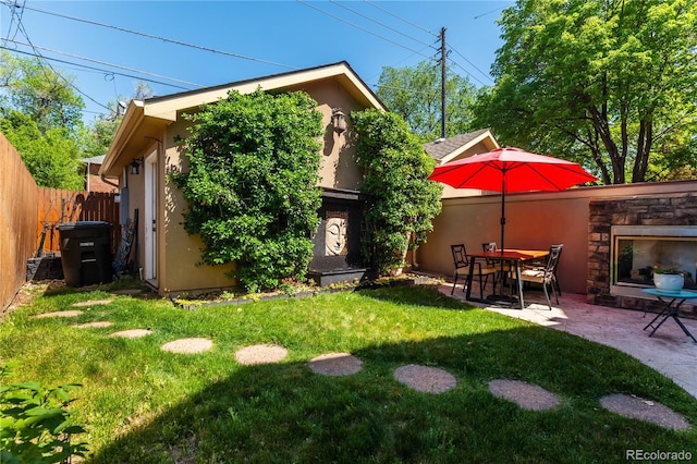 690 S Emerson St, Denver, CO 80209 - rear view of house with stucco siding, a patio area, and stone siding