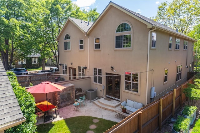 690 S Emerson St, Denver, CO 80209 - rear view of property featuring stucco siding, a fenced backyard, and a patio