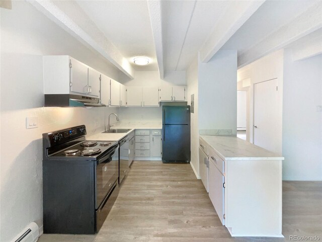 2401 S Gaylord St Unit 206, Denver, CO 80210 - kitchen featuring black appliances, under cabinet range hood, a baseboard heating unit, and light wood-style flooring