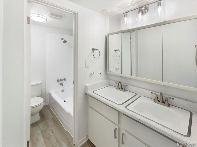 2401 S Gaylord St Unit 206, Denver, CO 80210 - full bathroom with wood finished floors, double vanity, and bathtub / shower combination