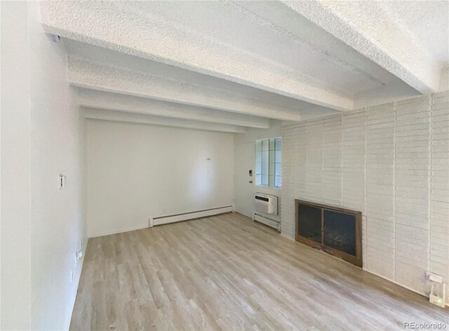 2401 S Gaylord St Unit 206, Denver, CO 80210 - unfurnished living room featuring a baseboard radiator, beam ceiling, a textured ceiling, wood finished floors, and a fireplace