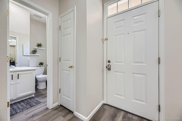 6819 S Webster St Unit B, Littleton, CO 80128 - foyer with wood finished floors and baseboards