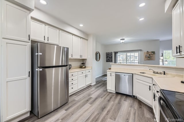 6819 S Webster St Unit B, Littleton, CO 80128 - kitchen with appliances with stainless steel finishes, recessed lighting, white cabinets, light countertops, and light wood-style floors