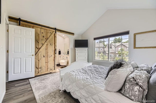6819 S Webster St Unit B, Littleton, CO 80128 - bedroom with a barn door, wood finished floors, and high vaulted ceiling