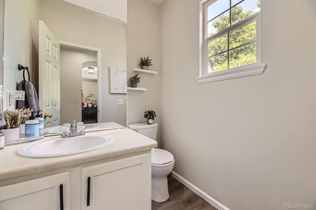6819 S Webster St Unit B, Littleton, CO 80128 - half bathroom with vanity and wood finished floors
