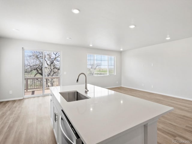 kitchen with a sink, dishwasher, plenty of natural light, a kitchen island with sink, and recessed lighting