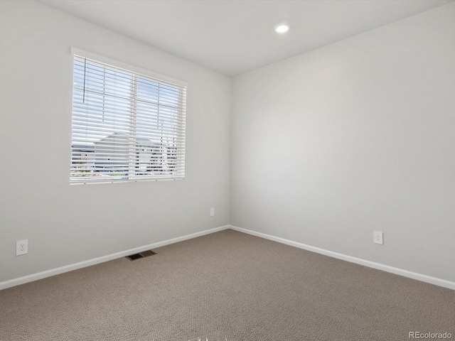 spare room featuring carpet, baseboards, and recessed lighting