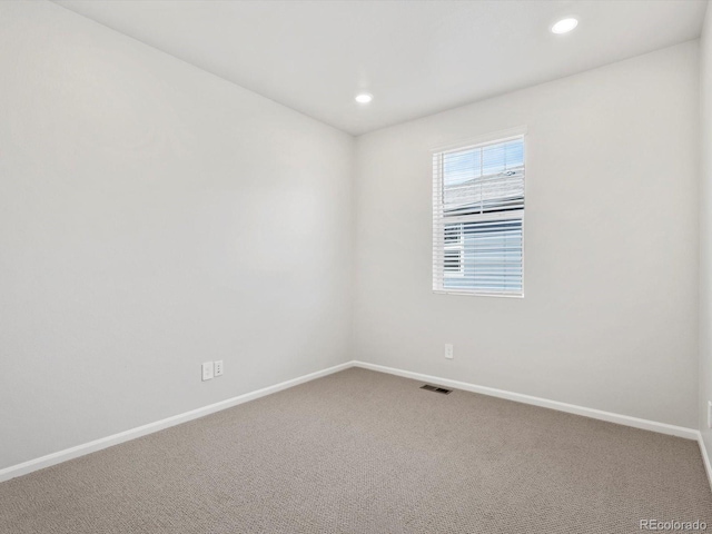 spare room with baseboards, carpet floors, and recessed lighting