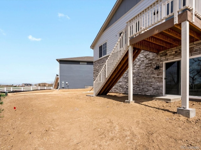 view of yard featuring stairs, a deck, and fence