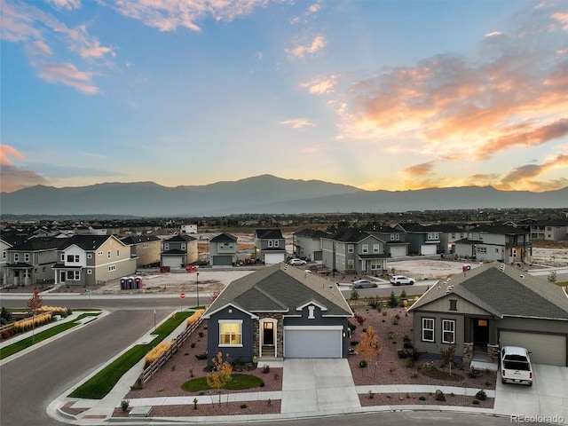 birds eye view of property with a mountain view and a residential view