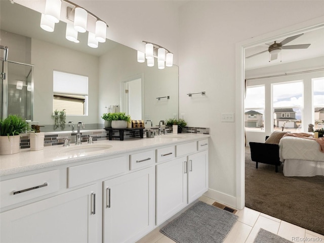 ensuite bathroom featuring a shower stall, visible vents, a sink, and ensuite bathroom